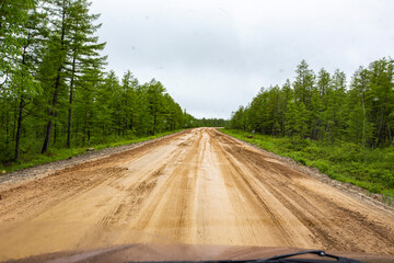 dirt road after rain in the mountains while traveling by motorhome