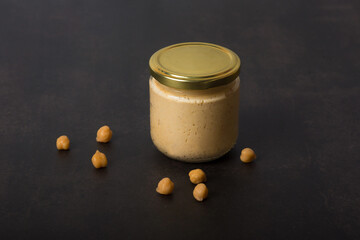 Hummus with cedar nuts in the jar and fresh pita
