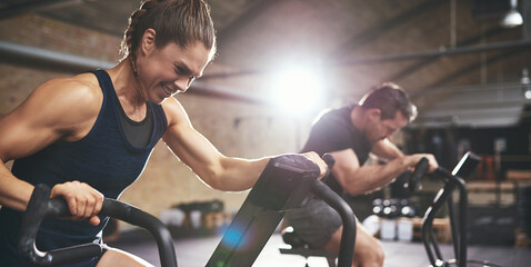 Fototapeta na wymiar Man and woman hardly exercising at gym