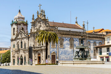 Fountain and church in historic city center of Porto, Portugal