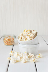 Popcorn and corn grains on a white background