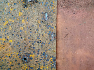 texture of old metal plates lying on top of each other and exposed to weather conditions, covered with rust, corrosion and rotted to holes