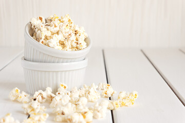 Popcorn in white bowls on a white background