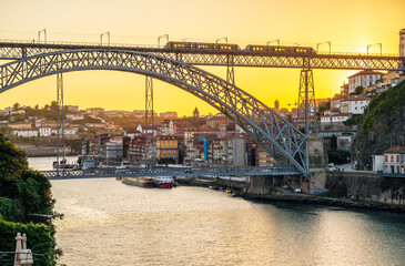 Cityscape of Porto with Douro river and famous bridge by sunset, Portugal