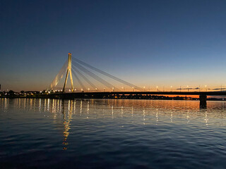 Cable-stayed bridge across the river. The bridge with night lighting.