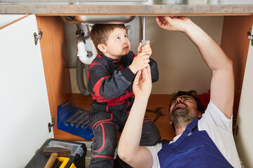 Father and son repair the broken sink