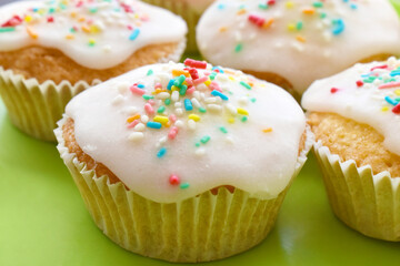 Sprinkle fairy cakes topped with light icing sugar and colourful sprinkles.