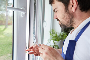 Fototapeta premium Window manufacturer carefully adjusts a window