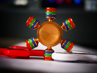 Selective focus shot of three metal fidget spinners