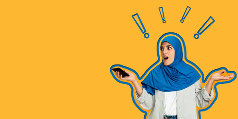 Happy arab woman in hijab with mobile phone. Portrait of smiling girl isolated over yellow background. Human emotions, facial expression concept.