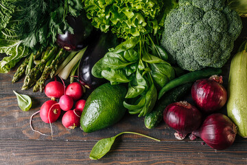 Variety of fresh vegetables radish, avocado, broccoli, eggplant,red onion,asparagus on the wooden...
