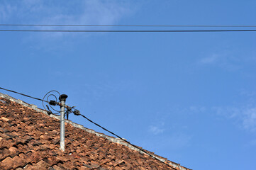 Electrical cable poles on the roof of the house