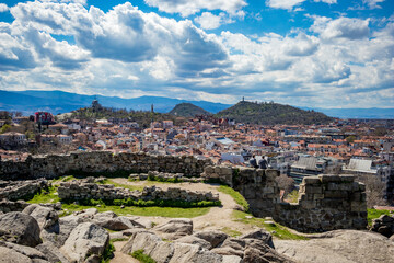 Fototapeta premium Plovdiv, Bulgaria, elevated cityscape view from Nebet Tepe, one of the city famous hills. Lovely cloudy blue sky.