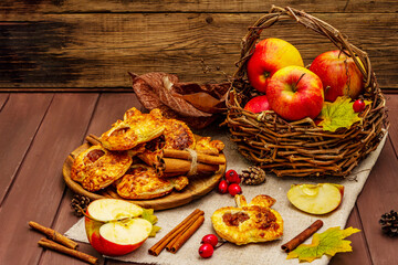 Homemade apple dessert, portioned puffs with fragrant cinnamon sticks, colorful foliage, autumn good mood