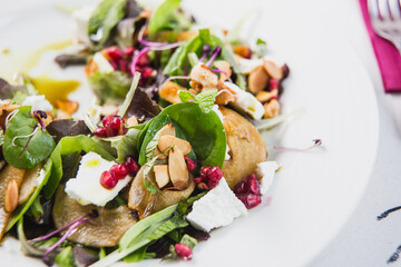 Healthy Diet Menu - Green salad with Arugula, baby spinach, pear slice topped with pumpkin seeds...