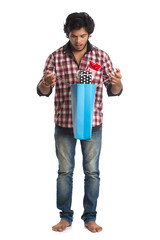 Fototapeta premium Young men showing rakhi on his hand with shopping bags and gift box on the occasion of Raksha Bandhan festival.