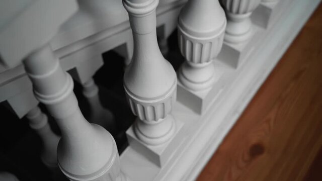White beautiful wooden railing on a beautiful staircase. Taking a close-up of an object
