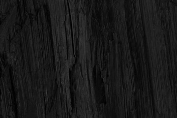Elegant and abstract black background. Black wood texture. Dark coal background close up.