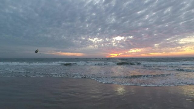 Beautiful sunset on the background of waves on Colva beach in Goa India