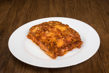 Tasty lasagna in bolognese sauce, made with ham cheese, tomato sauce and ground beef.