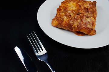 Lasagna in Bolognese sauce, made with ham cheese, tomato sauce and ground beef. Empty space for texts.
