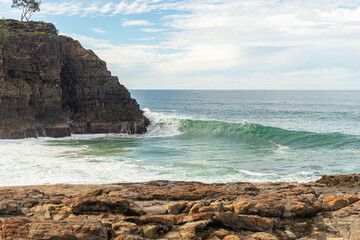 Scenic View of waves sweeping into the Coast on Noosa, Queensland, Australia.