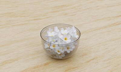 Glass bowl full of plumeria flowers on wooden floor