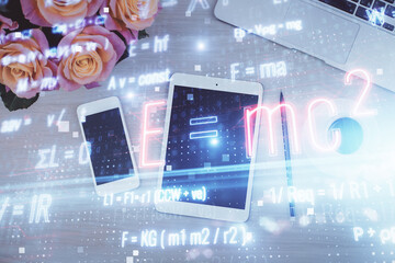 Obraz premium Double exposure of formula drawing over table with phone. Top view. Education concept.