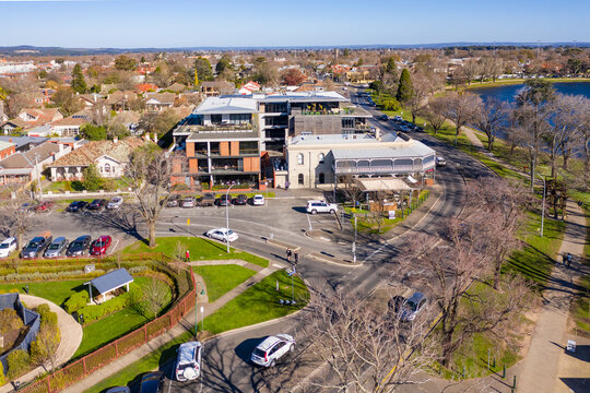 Aerial view of a hotel complex on a busy lakeside road