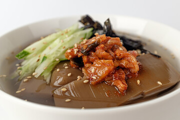 Noodles in a bowl of jelly on a white background
