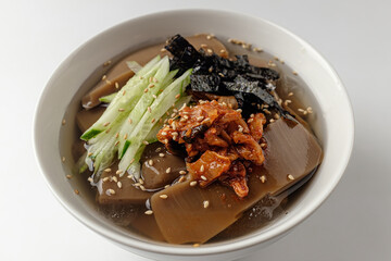 Noodles in a bowl of jelly on a white background