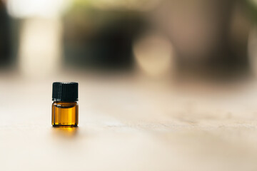 Close up image of 1ml amber essential oil vial. Health and wellness sample with copy space.
