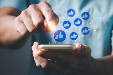  Concept with notification icons of like above smartphone screen,Social media interactions on mobile phone, a man's left hand holding device, internet digital marketing.
