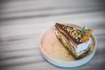 top view angle of banoffee, sweet and delicious homemade bekery, a piece of cake, recipe made from bananas, cream, chocolate and a thick caramel sauce. pastry in wood background