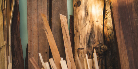 Background image of furniture woodworking workshop, carpenters industrial wooden material work table with different craft tools and wood cutting stand, vintage filter image.