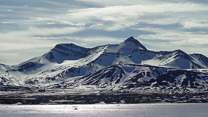 snow covered mountains.  Magnificent landscape with snow, iceberg, mountains, sky and sea, Yoldiabukta, Spitsbergen, Norway 