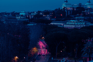 Cool long exposure cars city traffic neon light trails at night. View from above, Rome, Italy