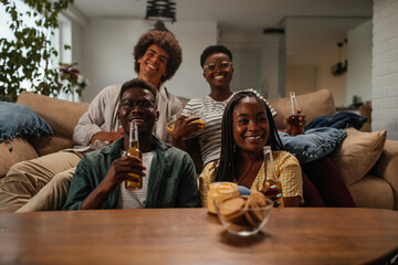 Friends drinking beer and having fun in the living room