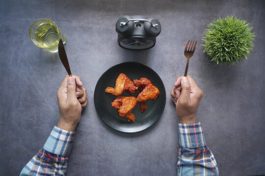  Man Hand With Knife And Fork Waiting For Eating Fried Chicken Fillets On Plate 