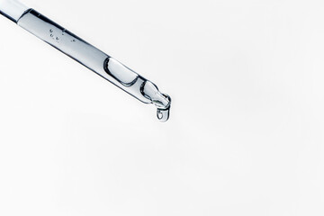 Liquid serum and dropper on a white background. Frontal view.