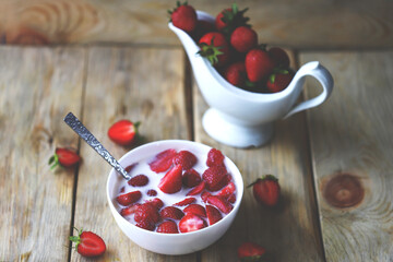 Strawberry milk or strawberries with cream in a bowl. Healthy summer dessert with strawberries.
