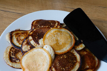 Fresh pancakes for breakfast on a plate.