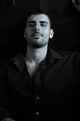 Portrait of handsome man with beard looking at camera with dark eyes