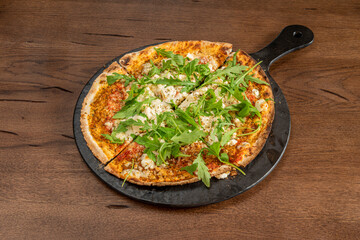 Pizza with a lot of feta cheese and arugula and with an oriental touch in the Turkish flour dough