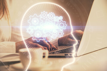Multi exposure of woman hands working on computer and human brain hologram drawing. Ai tech concept.