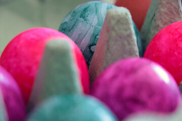 Out of focus. Blurred background. Colored eggs in a box.