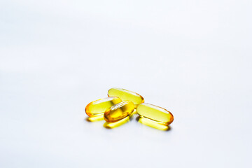 Fish oil capsules on white background and texture., Fish oil capsules and container., selective focus.