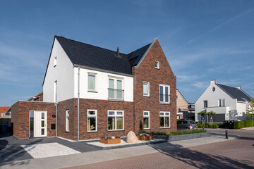 Dutch Suburban area with modern family houses, newly build modern family homes in the Netherlands, dutch family house, apartment house. Netherlands - obrazy, fototapety, plakaty