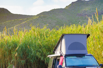 Camper van with roof top tent camp on nature