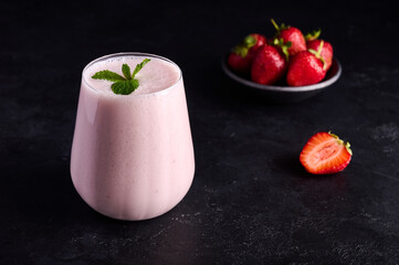 Lassi is traditional Indian cold refreshing drink with yoghurt, strawberry, mint and ice. Perfectly...